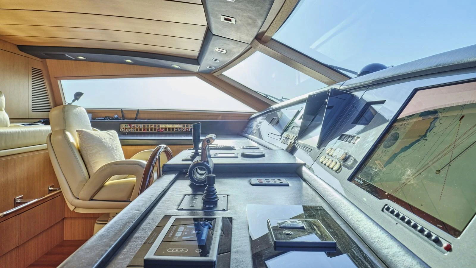 The helm station features advanced navigation equipment and luxurious seating, offering a commanding view for the captain. aboard OASIS Yacht for Sale