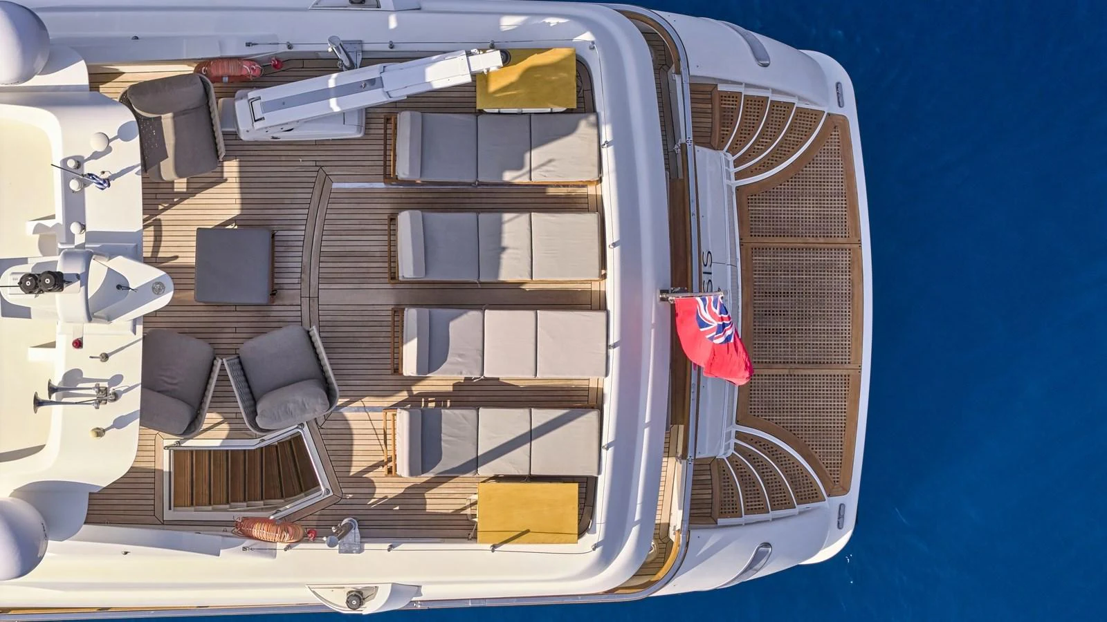 The sundeck offers a luxurious space for relaxation with sun loungers and a stunning view of the sea. aboard OASIS Yacht for Sale