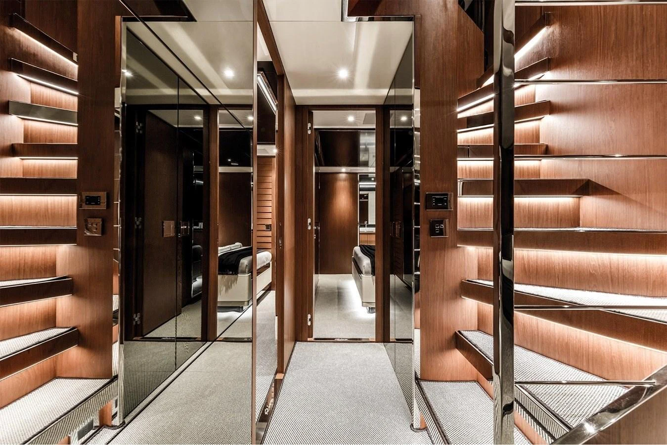 The interior features a modern design with sleek wooden finishes and mirrored accents. aboard GORA V Yacht for Sale
