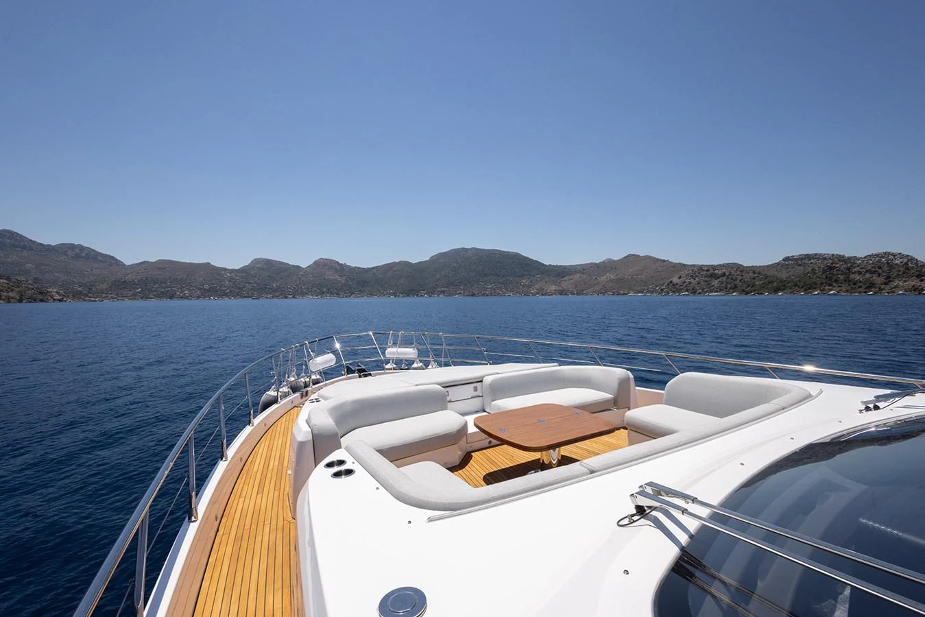 The foredeck features a spacious seating area with a central table, perfect for enjoying the scenic views. aboard MILES Yacht for Sale