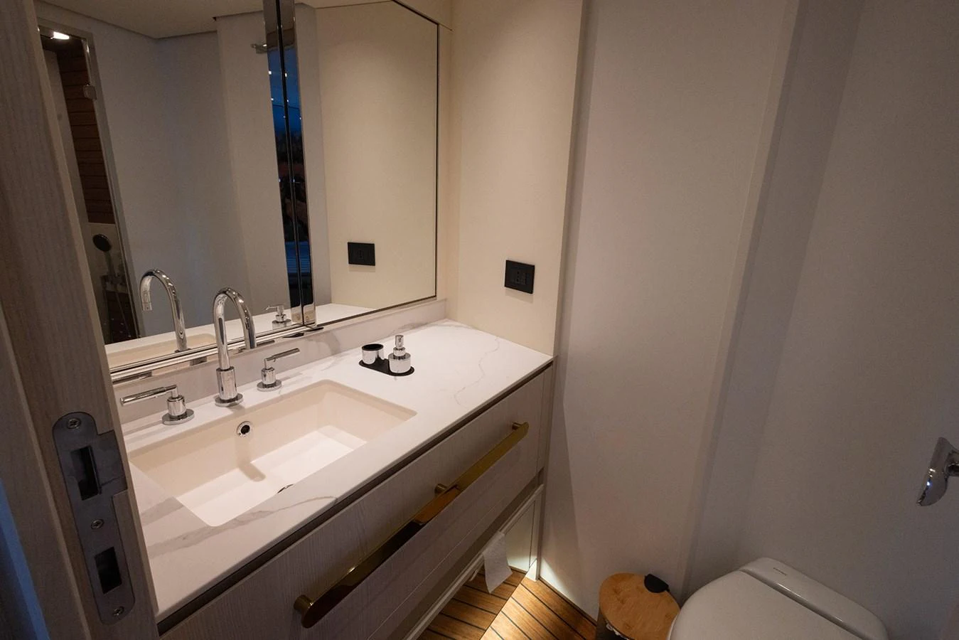 This elegant yacht bathroom features a sleek vanity with modern fixtures and a clean, minimalist design. aboard MILES Yacht for Sale