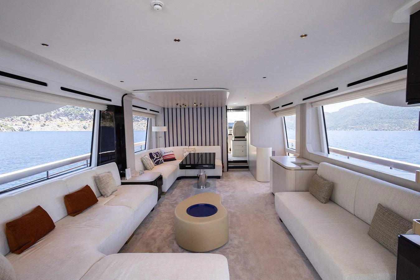 The yacht's salon features spacious seating areas with panoramic windows offering stunning views. aboard MILES Yacht for Sale