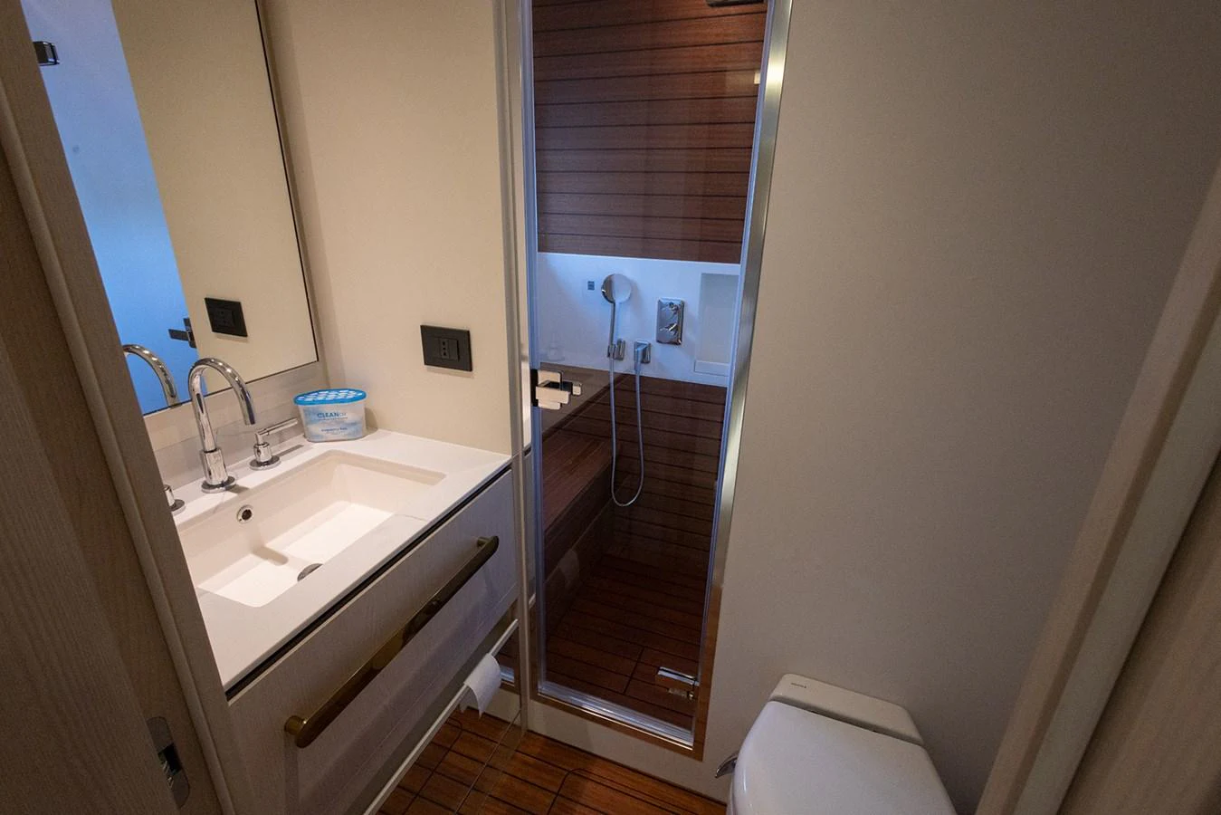 A modern yacht bathroom featuring a sleek sink and shower area. aboard MILES Yacht for Sale