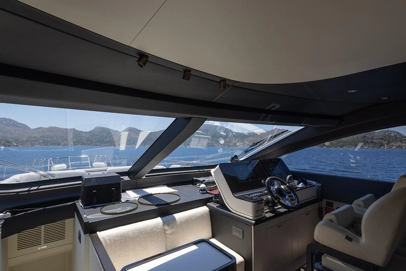 The helm station offers a sleek and modern design with panoramic views of the surrounding waters. aboard MILES Yacht for Sale