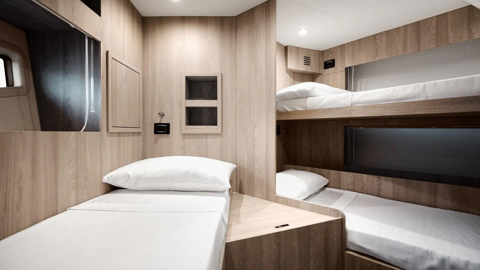 The crew quarters feature practical and comfortable bunk beds with a clean, minimalist design. aboard MILES Yacht for Sale