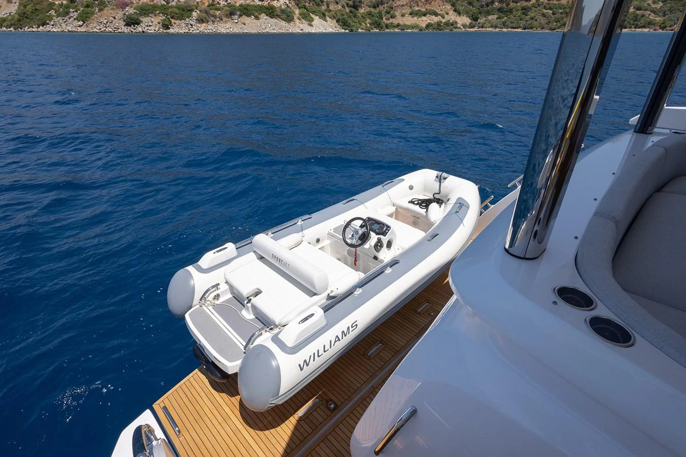 A sleek tender is docked alongside the yacht, ready for excursions. aboard MILES Yacht for Sale