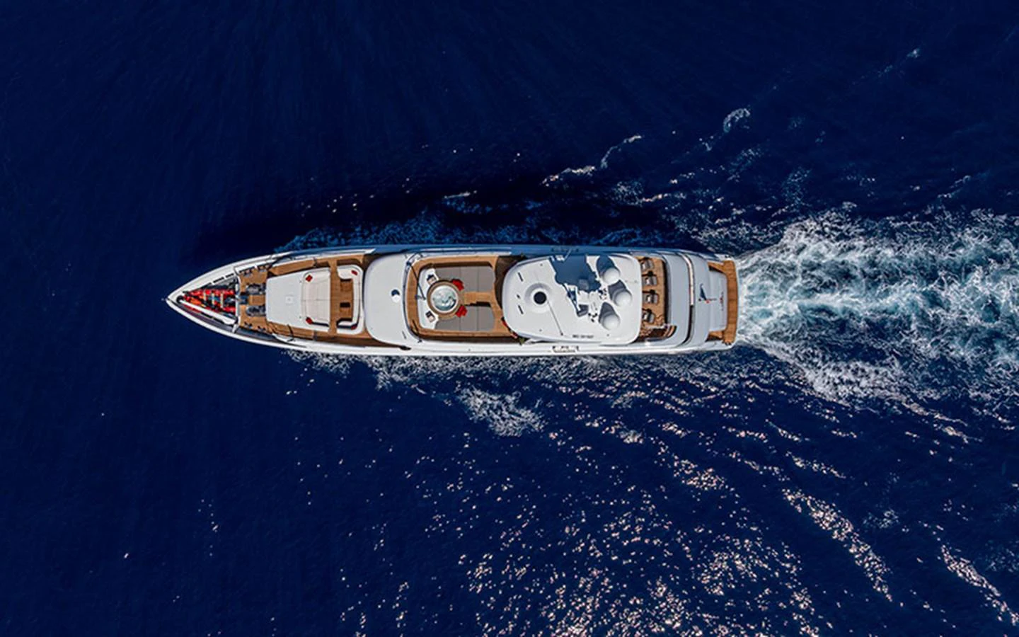 An aerial view of a luxurious yacht cruising through deep blue waters. aboard 2 LADIES Yacht for Sale