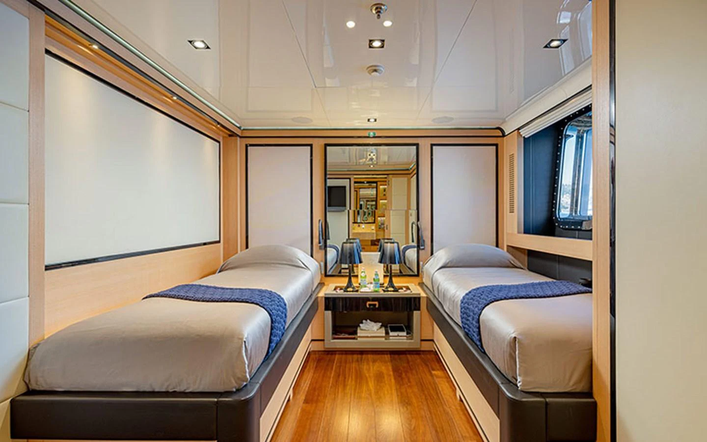 A luxurious twin stateroom with modern furnishings and ample lighting. aboard 2 LADIES Yacht for Sale