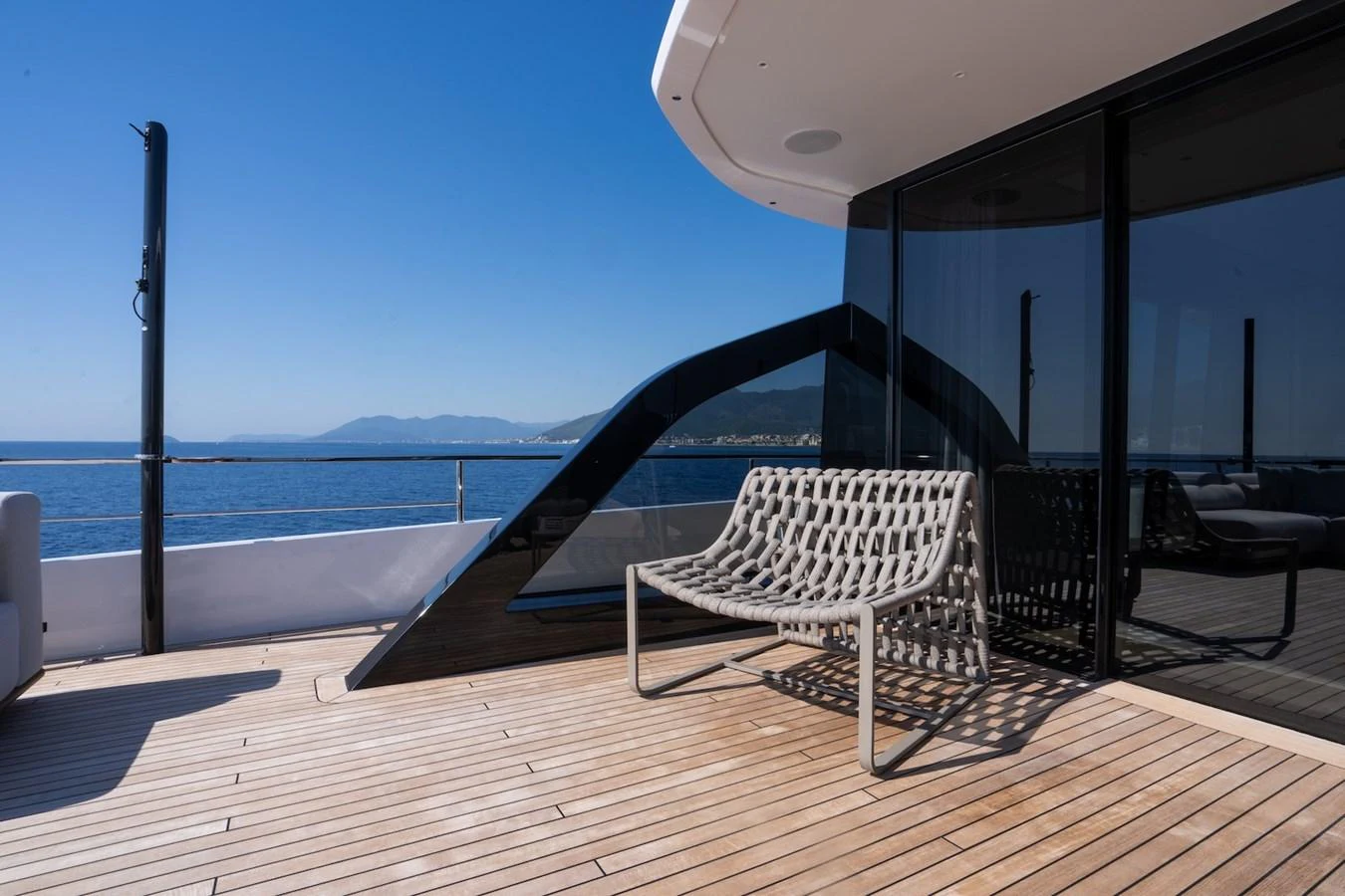 The yacht's aft deck features a stylish seating area with stunning ocean views. aboard COME TOGETHER Yacht for Sale
