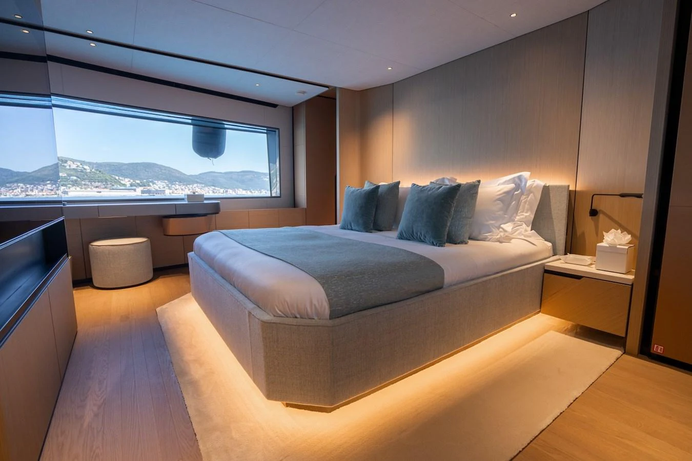 A luxurious stateroom with a large bed and scenic window view. aboard COME TOGETHER Yacht for Sale