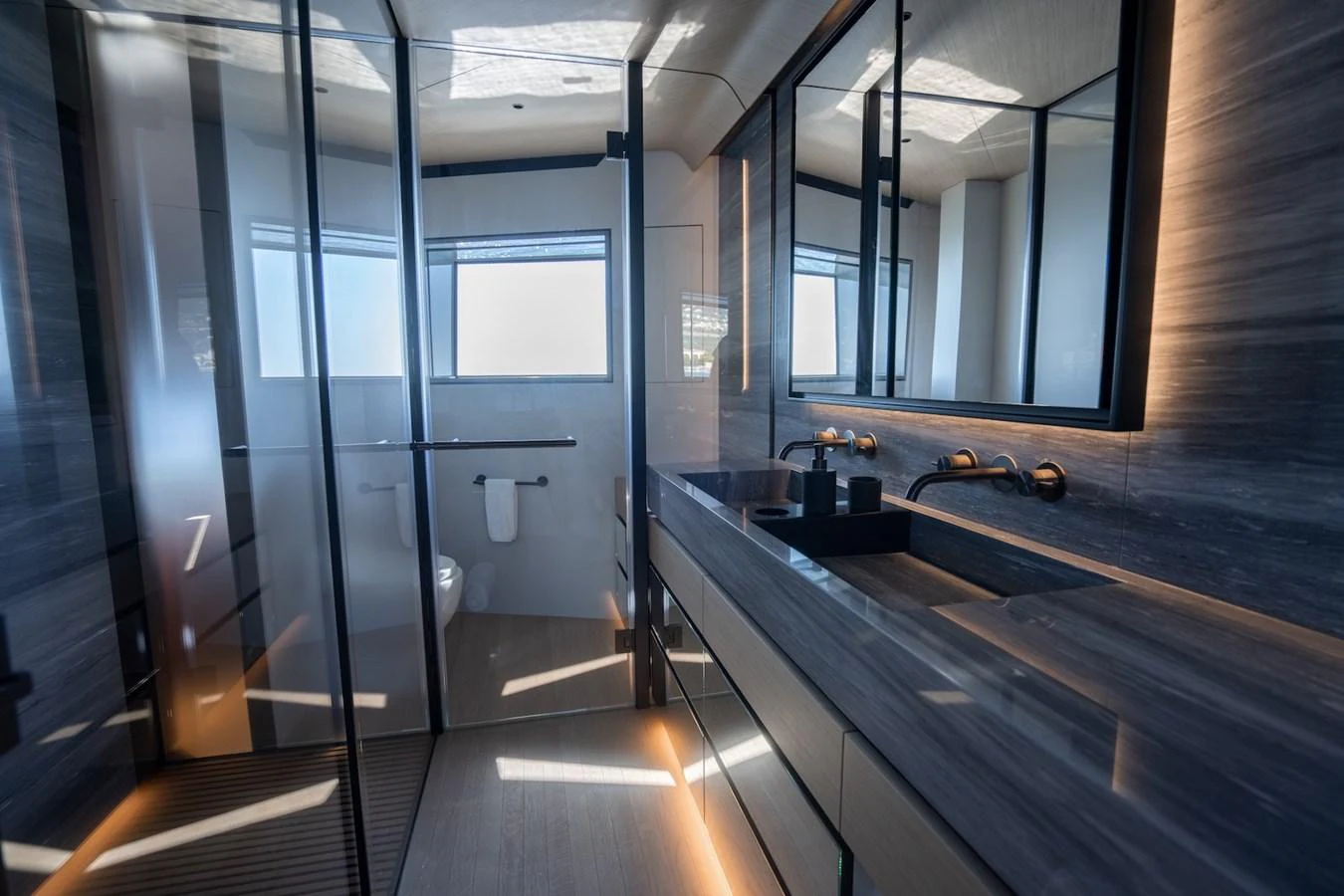 The yacht's bathroom features sleek, modern design with ample natural light and high-end fixtures. aboard COME TOGETHER Yacht for Sale