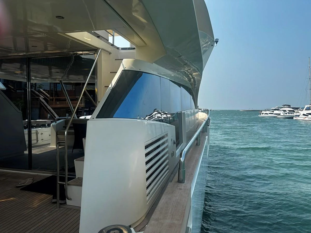 The yacht is docked, showcasing its sleek exterior design and modern lines. aboard GALLEN Yacht for Sale