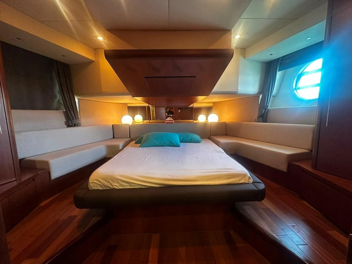 The master stateroom features a spacious bed with elegant lighting and ample seating. aboard GALLEN Yacht for Sale