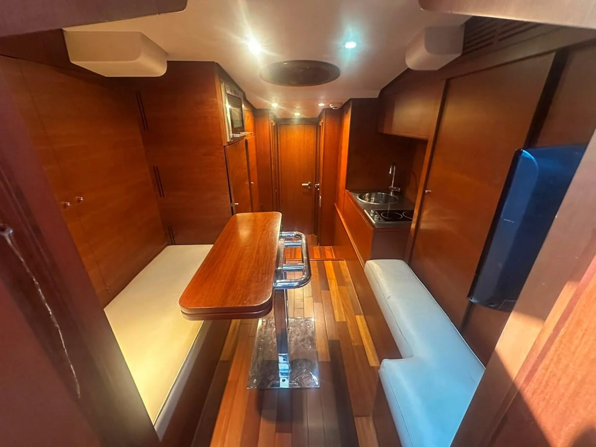 The galley features a cozy dining area with wooden finishes and modern amenities. aboard GALLEN Yacht for Sale