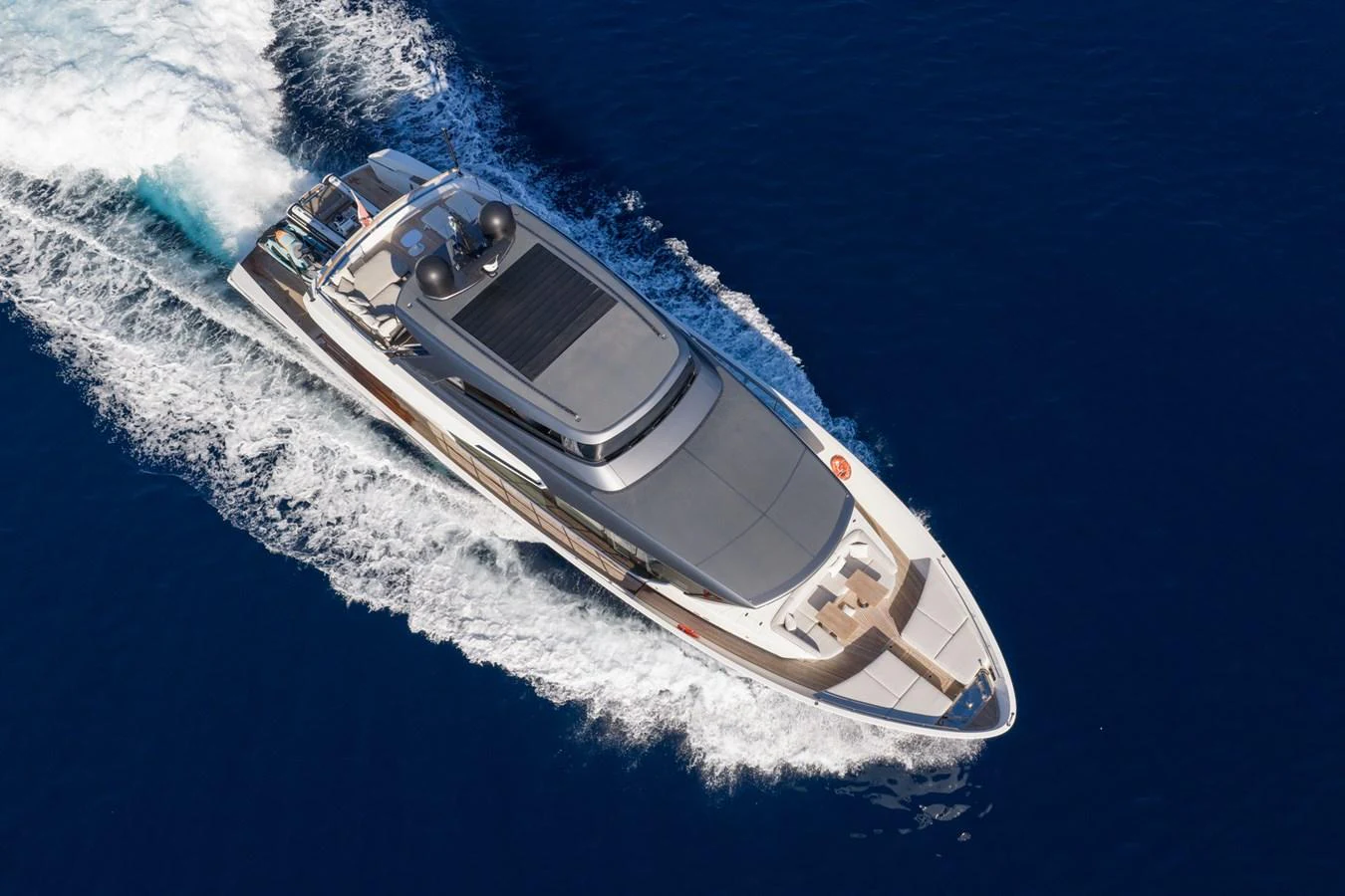 A sleek and modern yacht glides swiftly through the deep blue sea, showcasing its elegant design and powerful performance. aboard JUNIOR Yacht for Sale