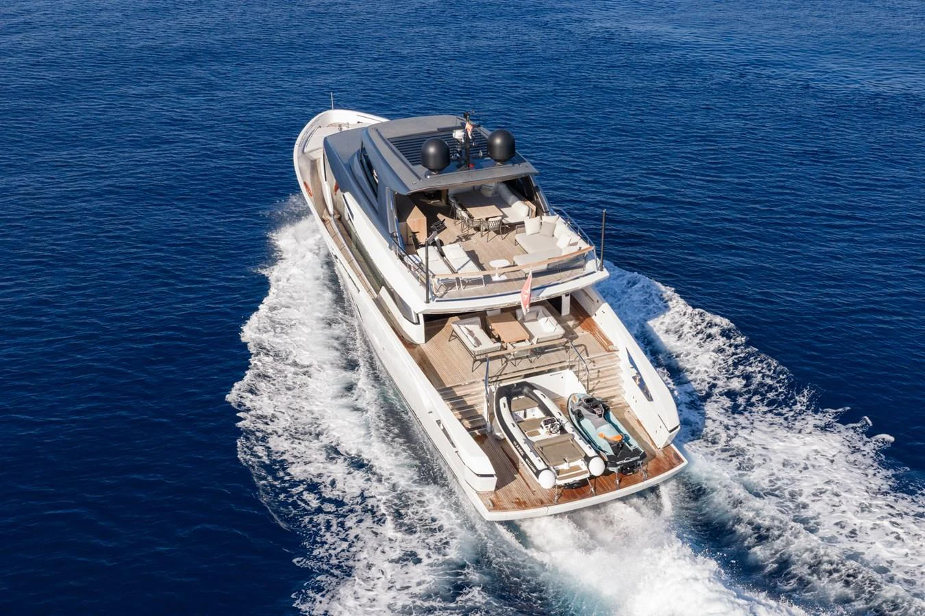 A luxurious yacht cruises through the open sea, showcasing its sleek design and spacious deck. aboard JUNIOR Yacht for Sale