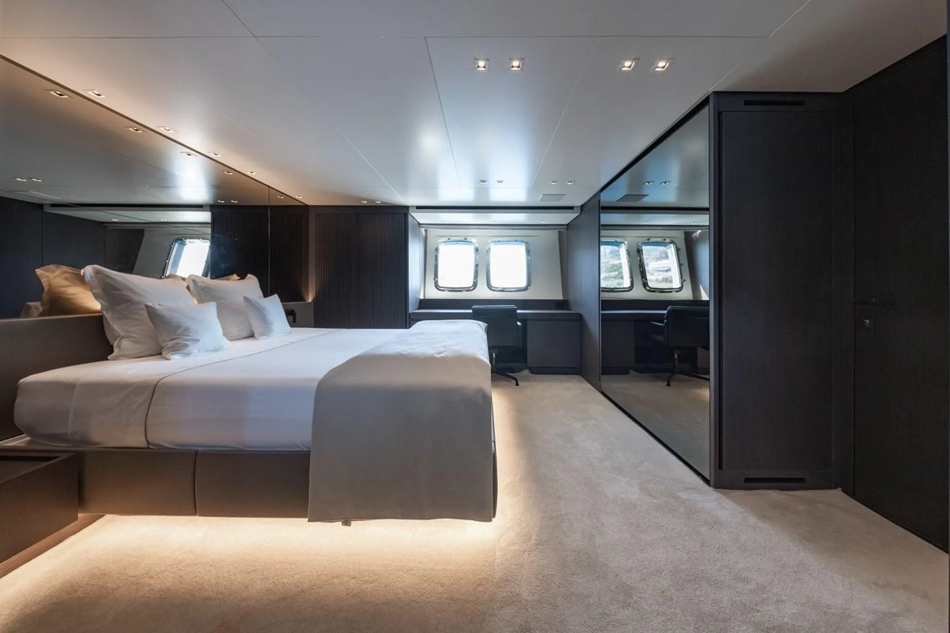 The master stateroom features a spacious bed, ample natural light, and luxurious finishes. aboard JUNIOR Yacht for Sale