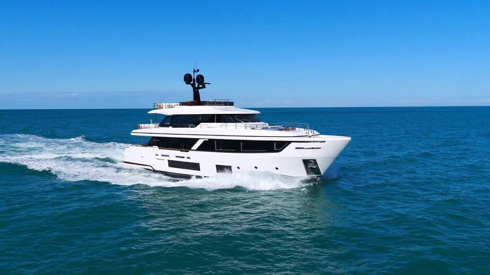 A sleek and modern yacht cruises through the open sea under a clear blue sky. aboard SOLE Yacht for Sale
