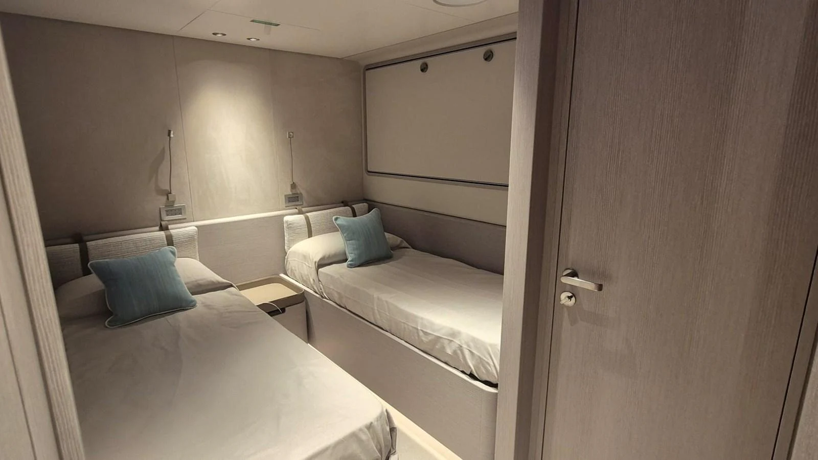 A cozy twin cabin with modern decor and soft lighting. aboard SOLE Yacht for Sale