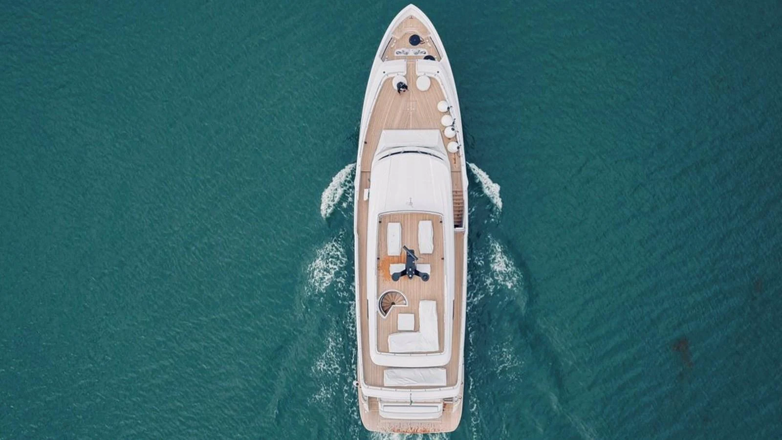 Aerial view of a yacht cruising through the water, showcasing its spacious deck layout. aboard SOLE Yacht for Sale