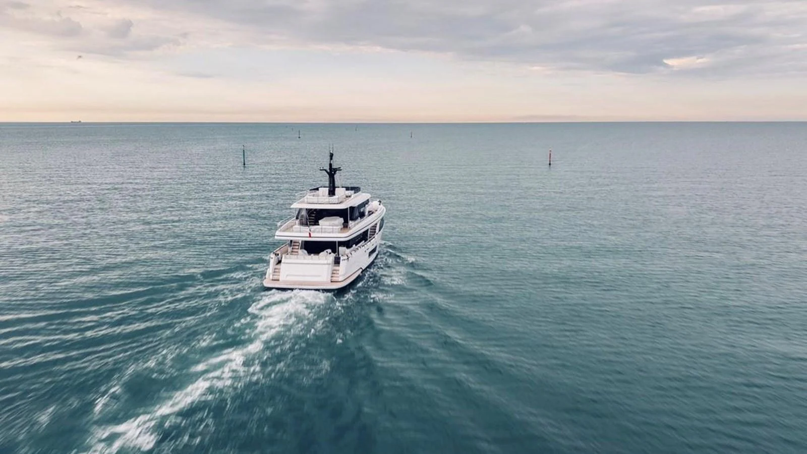 A luxurious yacht cruises through calm waters under a serene sky. aboard SOLE Yacht for Sale