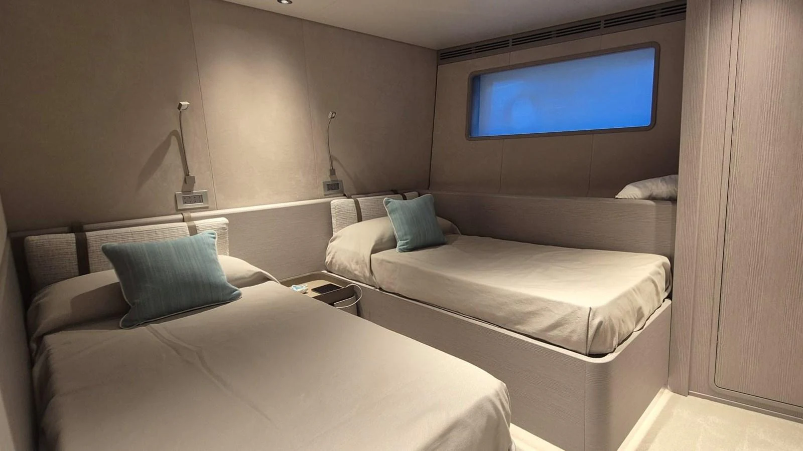 The guest stateroom features twin beds with a modern, minimalist design and soft lighting. aboard SOLE Yacht for Sale