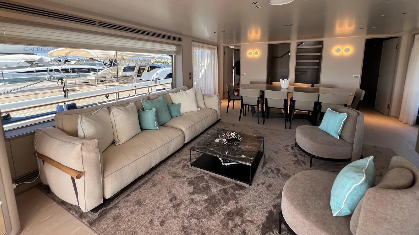 The salon offers a spacious and elegant seating area with a view of the marina. aboard SOLE Yacht for Sale