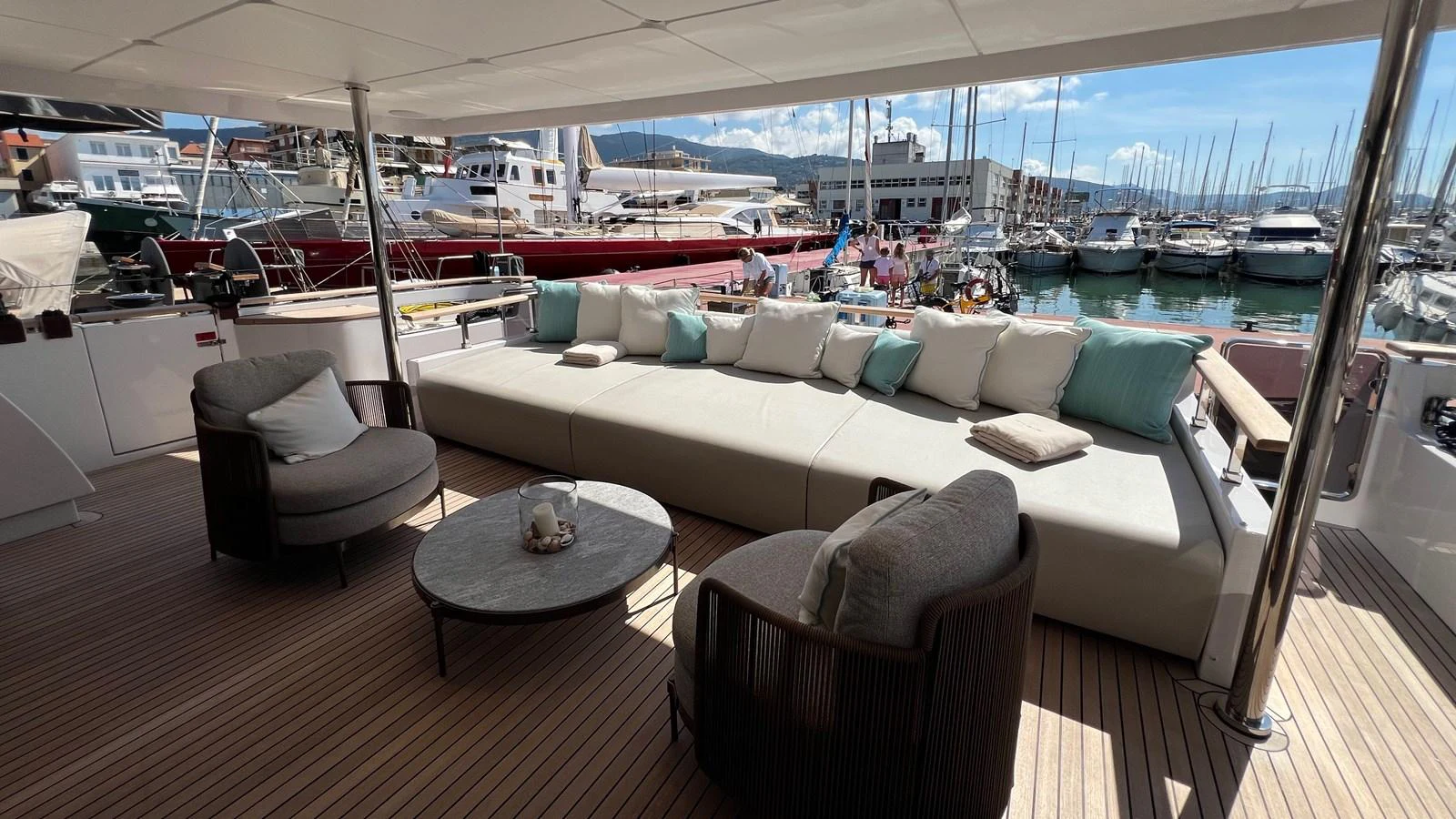 The aft deck features a spacious seating area with comfortable chairs and a large sofa, perfect for relaxation. aboard SOLE Yacht for Sale