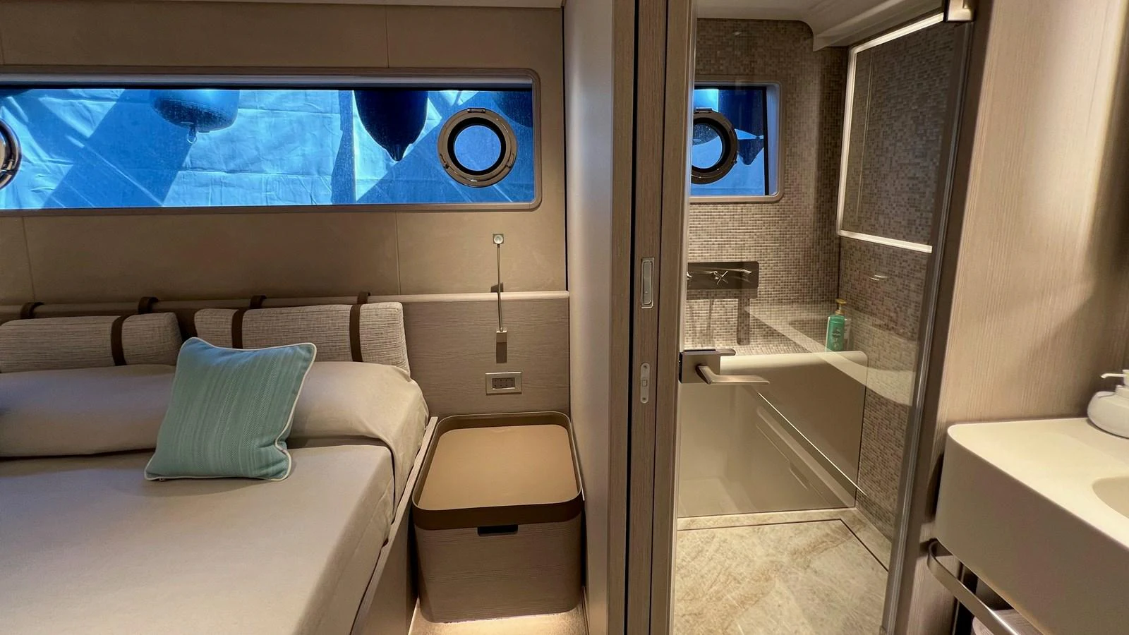 A cozy stateroom with an en-suite bathroom, featuring modern design and soft lighting. aboard SOLE Yacht for Sale