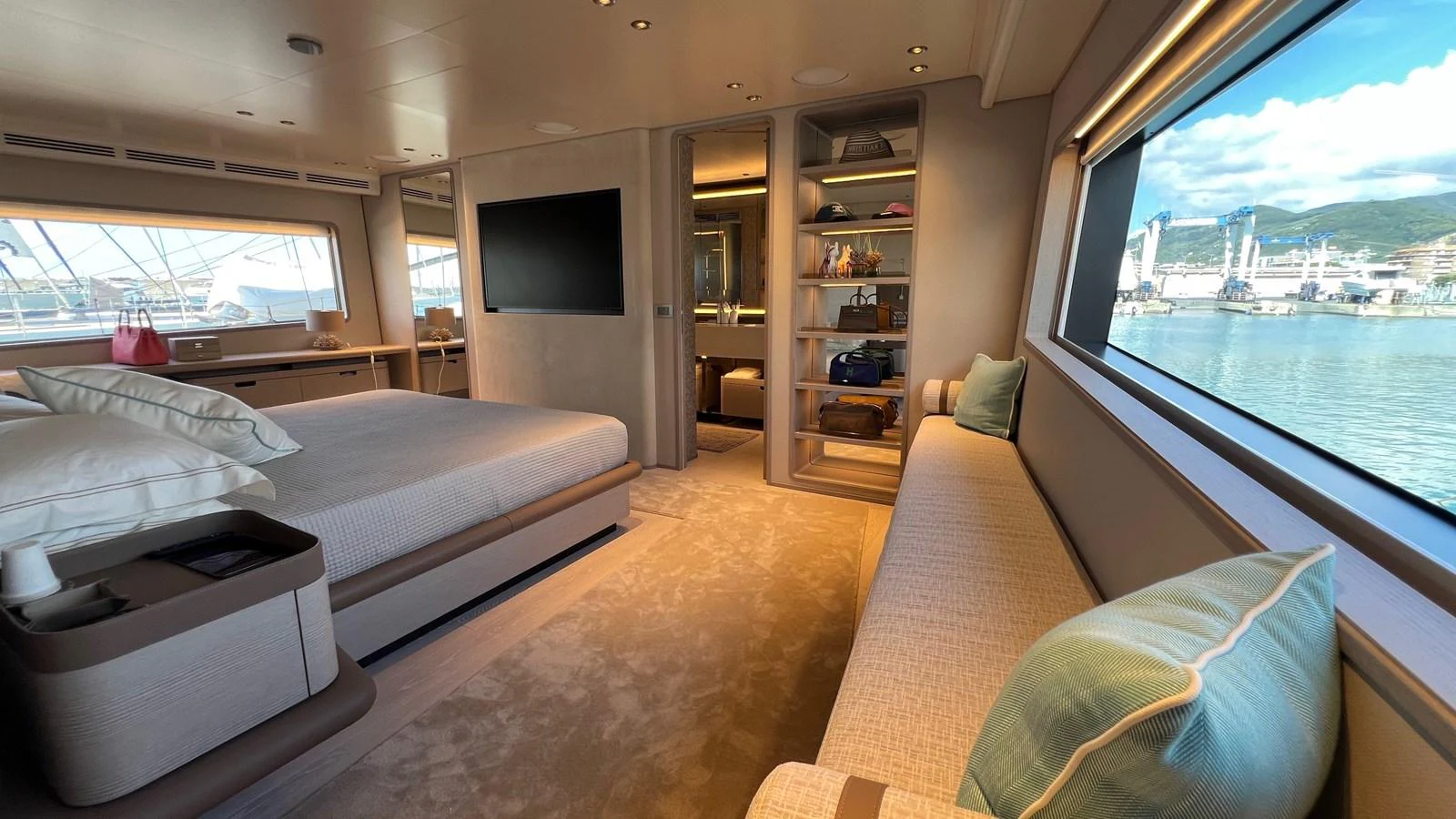 A luxurious stateroom with a large bed, ample storage, and panoramic windows offering stunning views. aboard SOLE Yacht for Sale