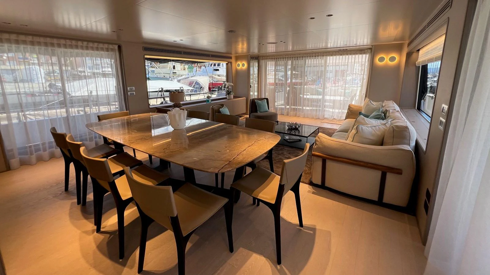 The yacht's salon features a spacious dining area and comfortable seating with ample natural light. aboard SOLE Yacht for Sale