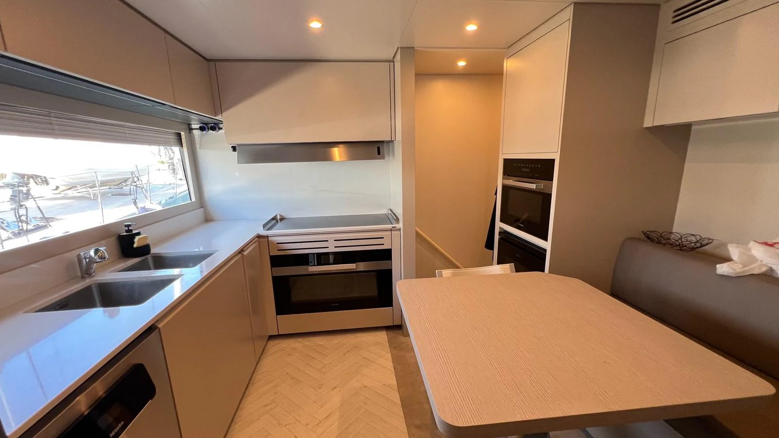 The yacht's galley is equipped with modern appliances and a cozy dining area. aboard SOLE Yacht for Sale