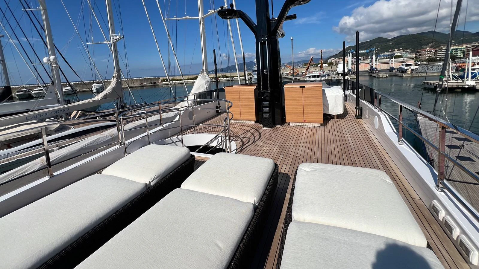 The sundeck offers a spacious area with plush sun loungers, perfect for relaxation while enjoying the marina view. aboard SOLE Yacht for Sale