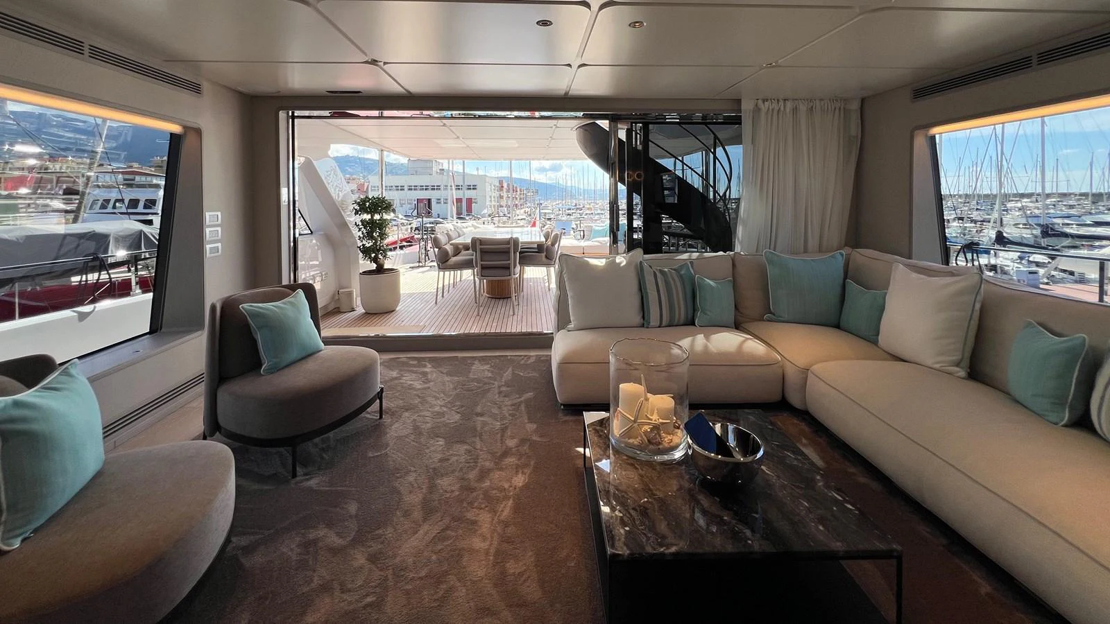 The salon offers a spacious and luxurious seating area with a view of the marina. aboard SOLE Yacht for Sale