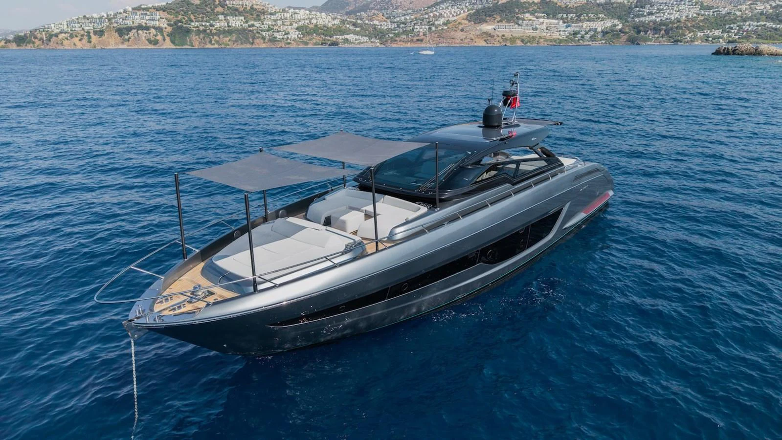 A sleek and modern yacht glides effortlessly on the clear blue waters, showcasing its elegant design and spacious deck areas. aboard LUCE I Yacht for Sale