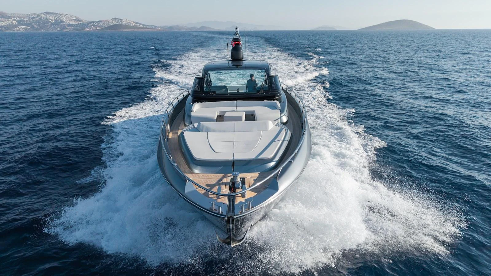 A sleek yacht cruises through the open sea, showcasing its modern design and powerful performance. aboard LUCE I Yacht for Sale