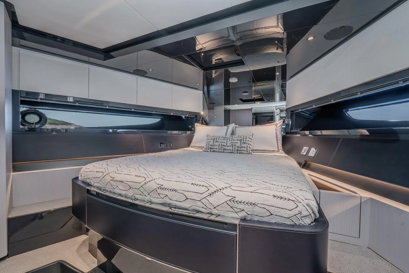 The stateroom features a luxurious bed with modern decor and ample lighting. aboard LUCE I Yacht for Sale