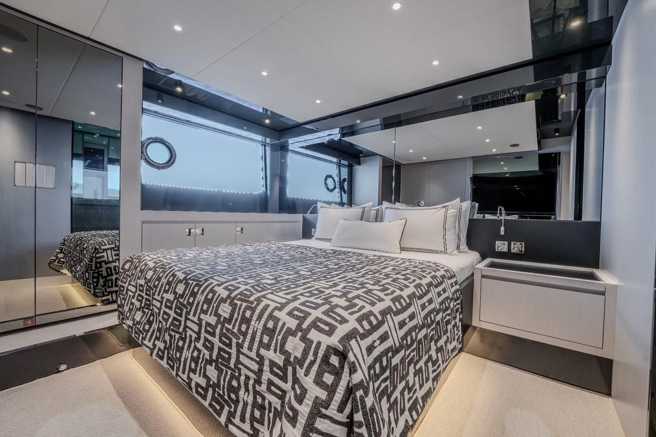 The stateroom features a luxurious bed with modern decor and ample lighting. aboard LUCE I Yacht for Sale
