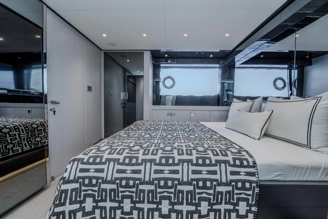 A luxurious stateroom featuring a plush bed with elegant bedding and modern decor. aboard LUCE I Yacht for Sale