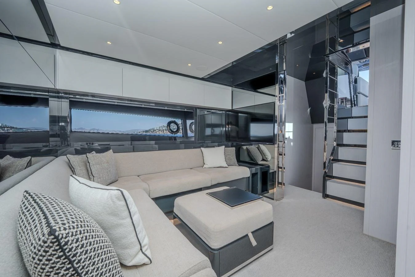 The salon features a spacious seating area with modern decor and ample natural light. aboard LUCE I Yacht for Sale