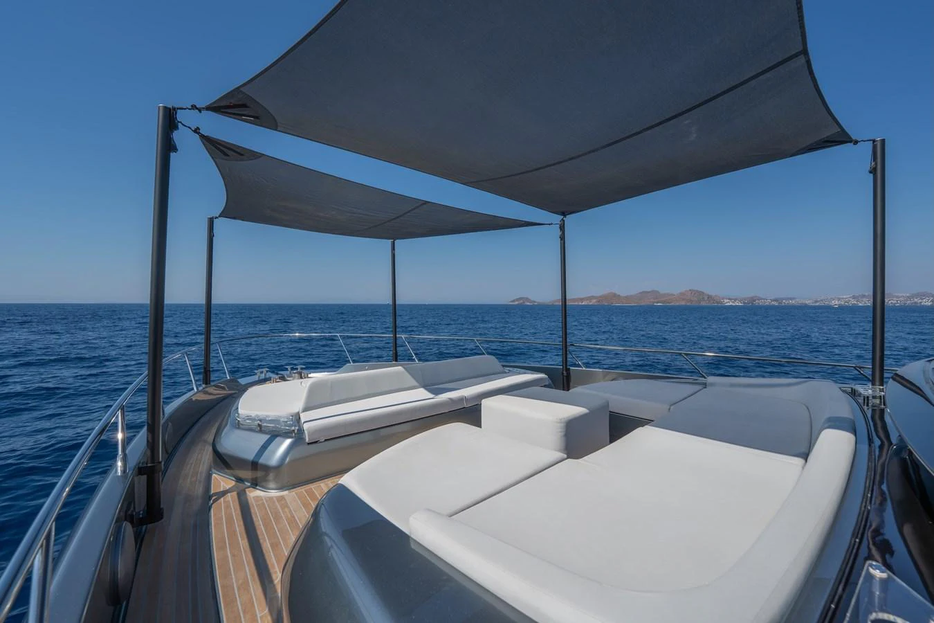 The sundeck offers luxurious lounging areas with sunshades and stunning ocean views. aboard LUCE I Yacht for Sale