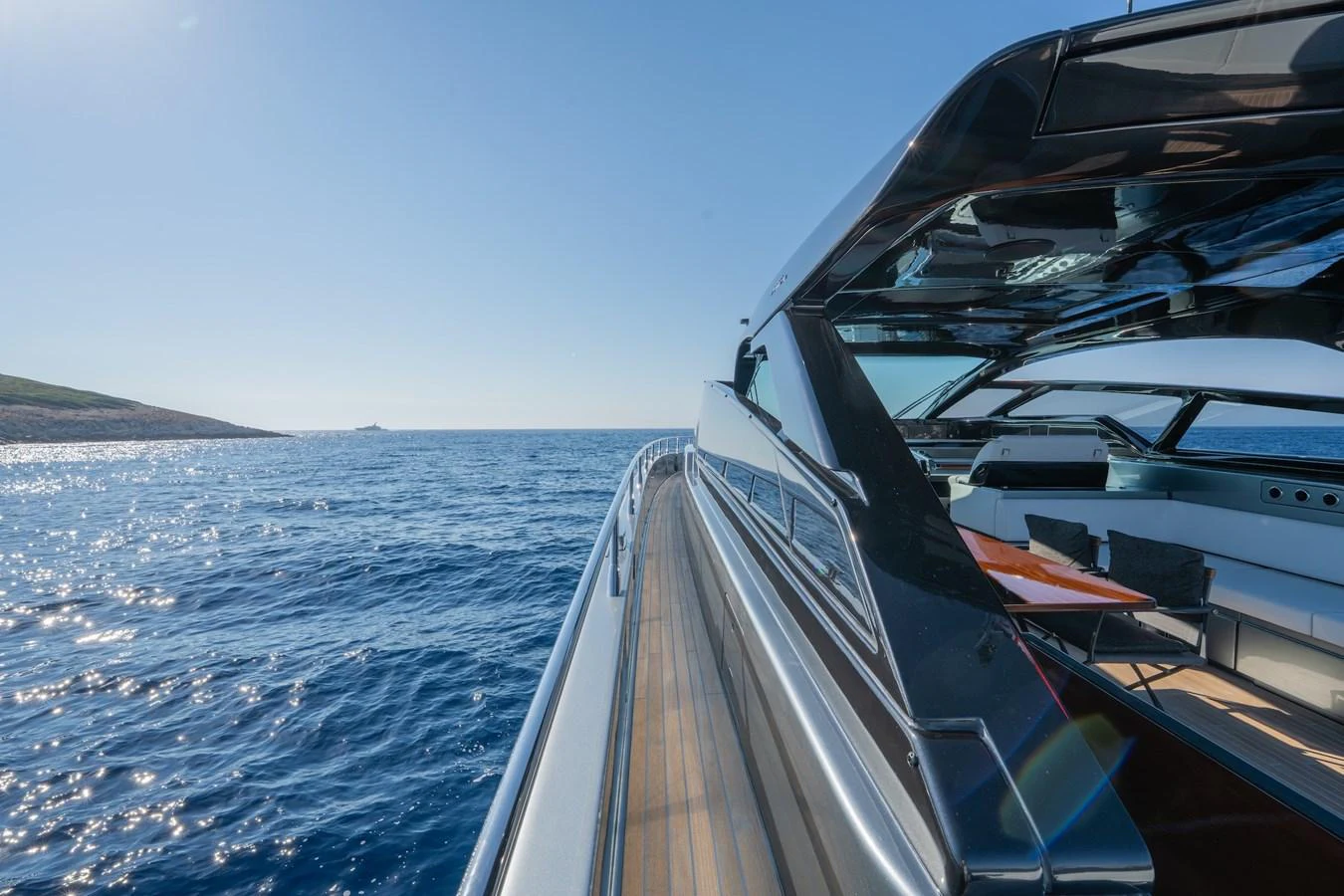 A sleek yacht cruising on open waters under a clear blue sky. aboard LUCE I Yacht for Sale