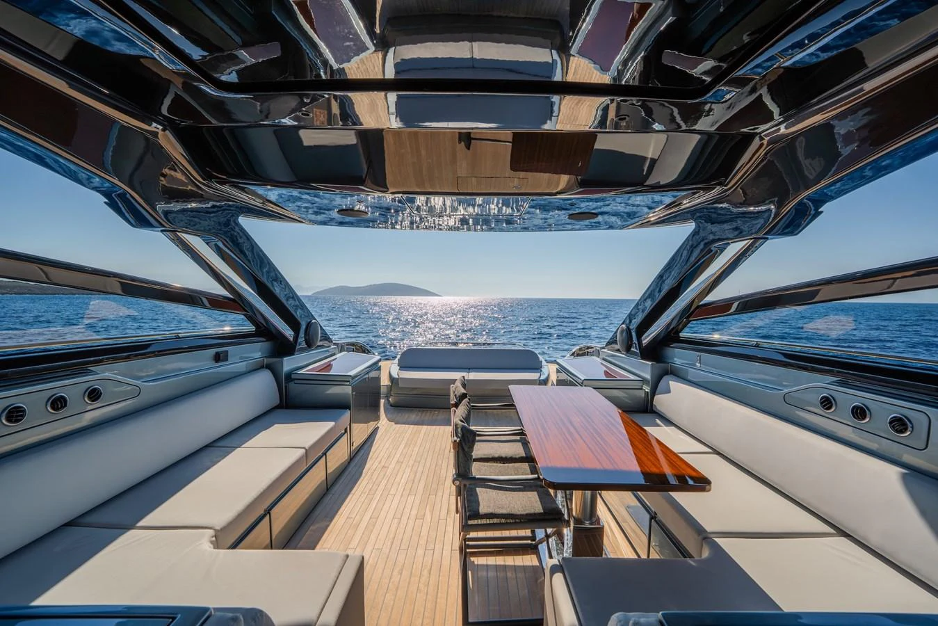 The aft deck offers a luxurious seating area with panoramic ocean views, perfect for relaxation and dining. aboard LUCE I Yacht for Sale