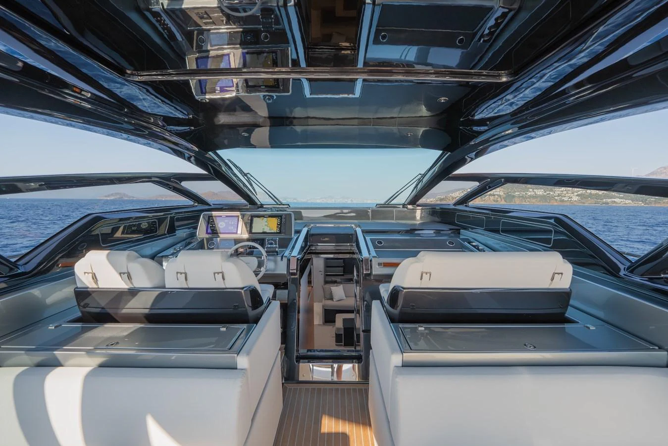 The helm station features modern navigation equipment and luxurious seating with panoramic views. aboard LUCE I Yacht for Sale