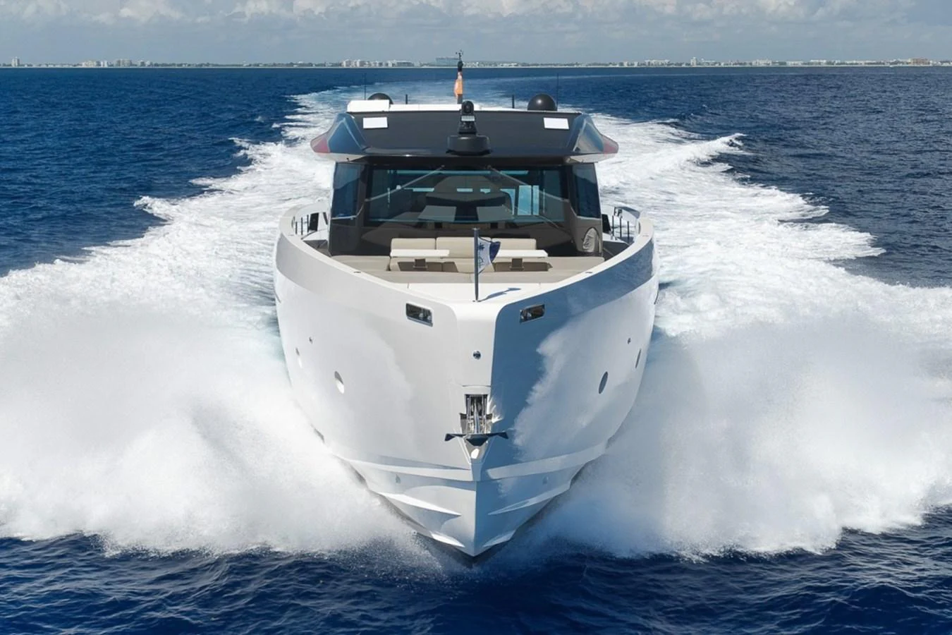 A sleek yacht cuts through the water with impressive speed and power. aboard LAUREN MARIE Yacht for Sale
