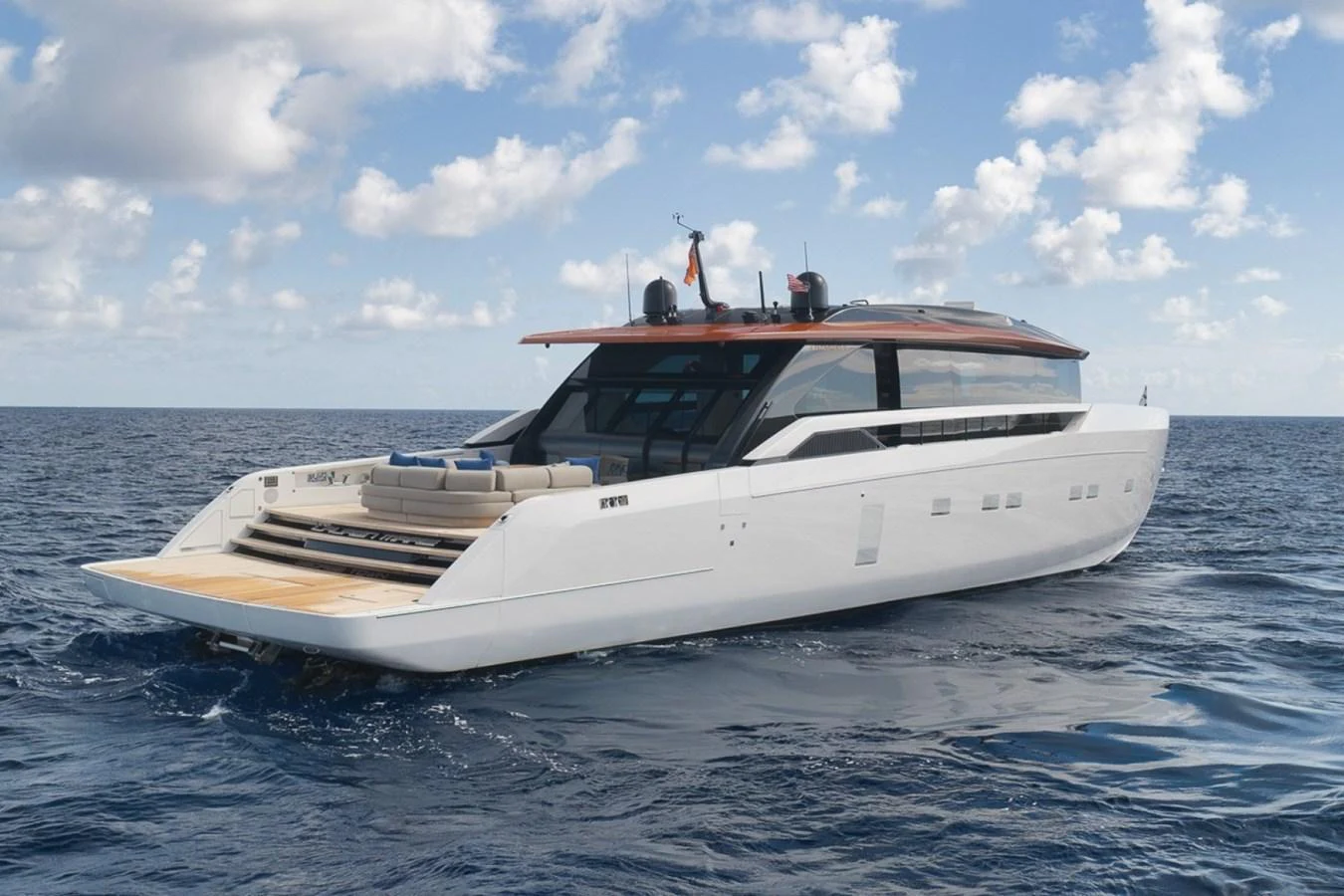 A sleek and modern yacht glides effortlessly on the open sea under a partly cloudy sky. aboard LAUREN MARIE Yacht for Sale
