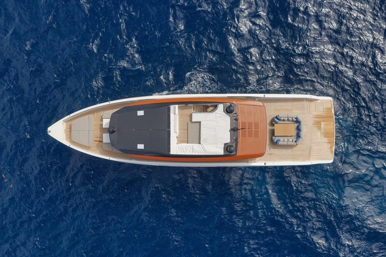An aerial view of a sleek yacht cruising through deep blue waters. aboard LAUREN MARIE Yacht for Sale