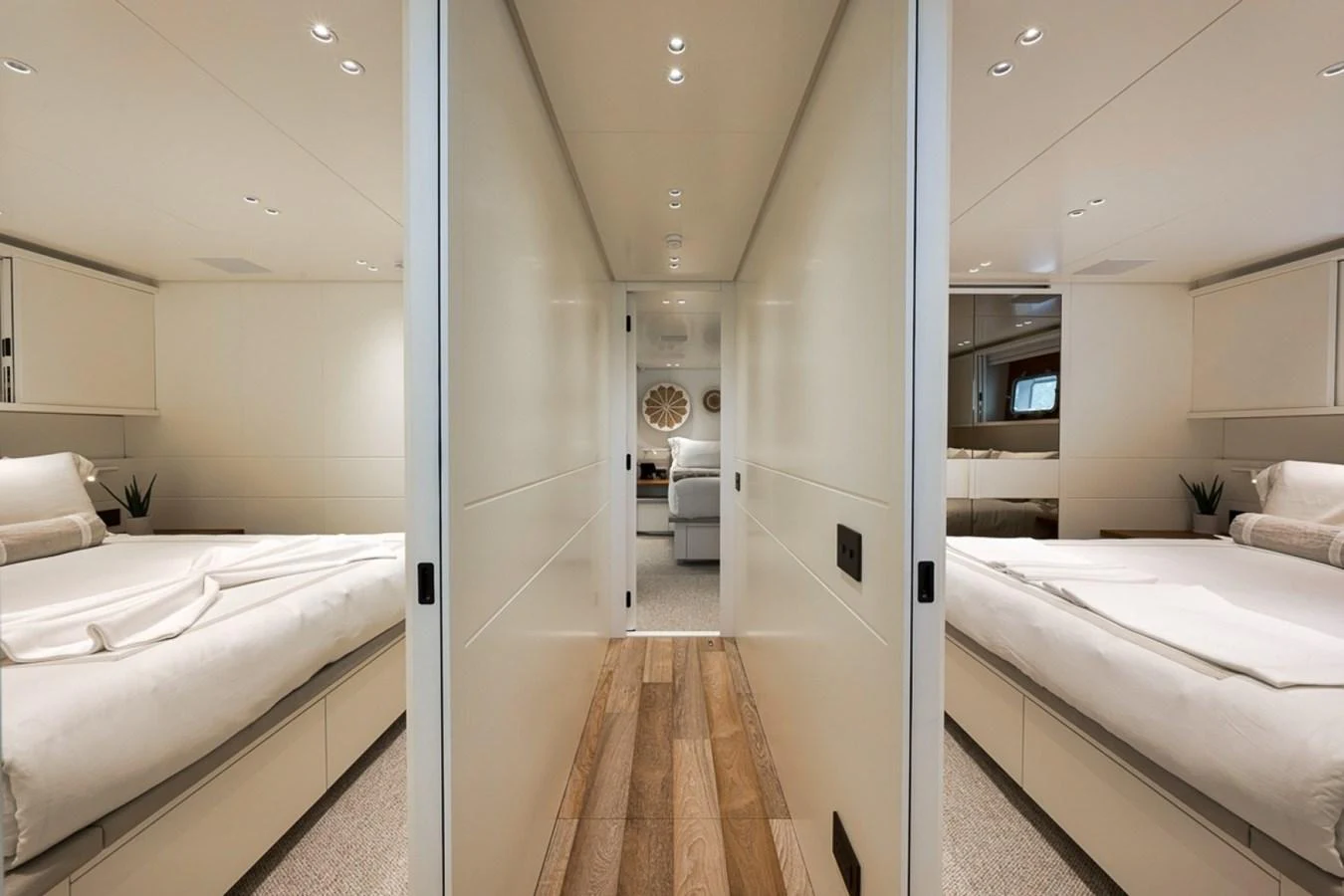 The image showcases a luxurious stateroom with twin beds and elegant decor. aboard LAUREN MARIE Yacht for Sale