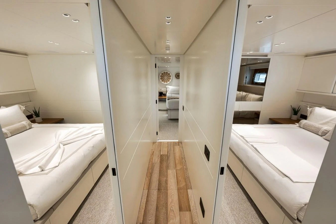 The image showcases a modern guest stateroom with twin beds and elegant decor. aboard LAUREN MARIE Yacht for Sale
