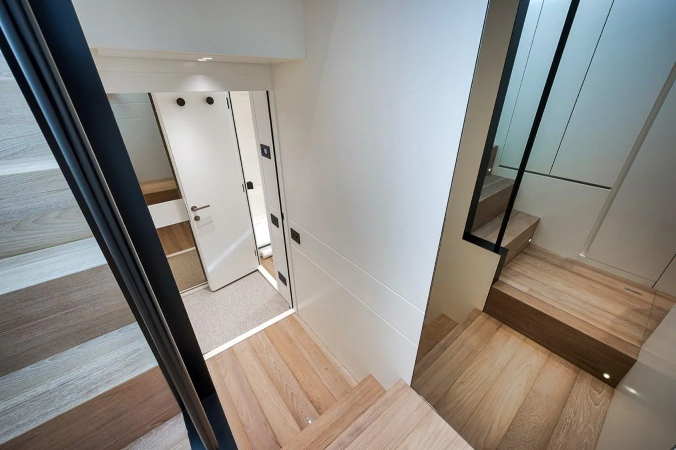The yacht's interior staircase features sleek wooden steps and modern design elements. aboard LAUREN MARIE Yacht for Sale